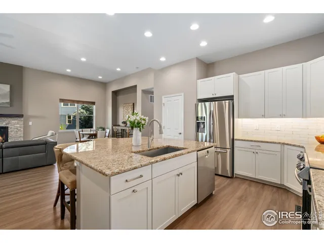 a kitchen with sink refrigerator and cabinets
