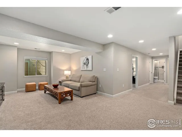 a living room with furniture a window and a flat screen tv