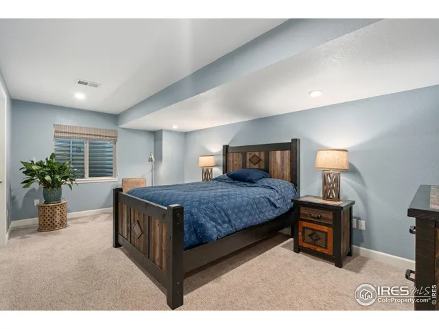 a bathroom with a sink a toilet a mirror and shower