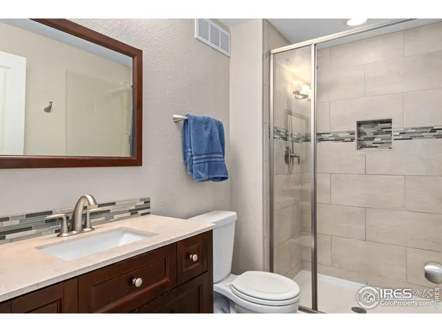 a bedroom with a bed and a night stand