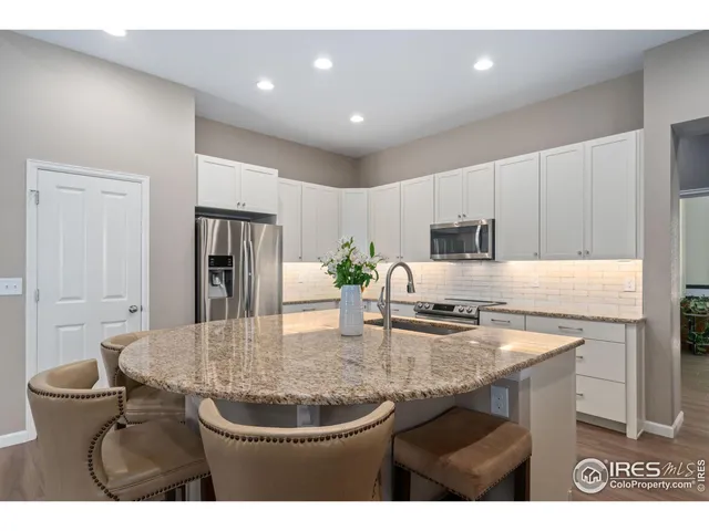a kitchen with a stove a sink and a refrigerator