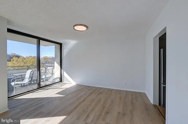 an empty room with wooden floor and door
