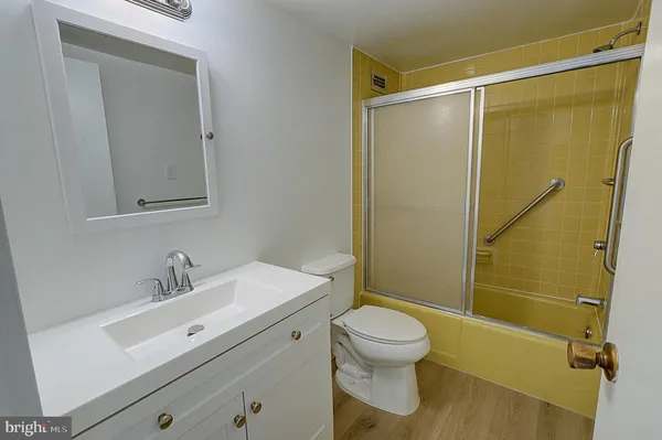 a bathroom with a sink mirror vanity and toilet