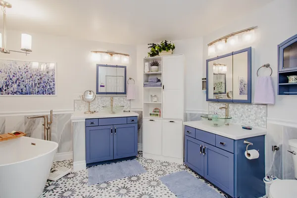 a bathroom with a sink vanity granite tub and a mirror