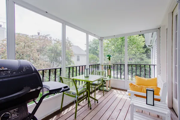 a balcony with furniture and a potted plant