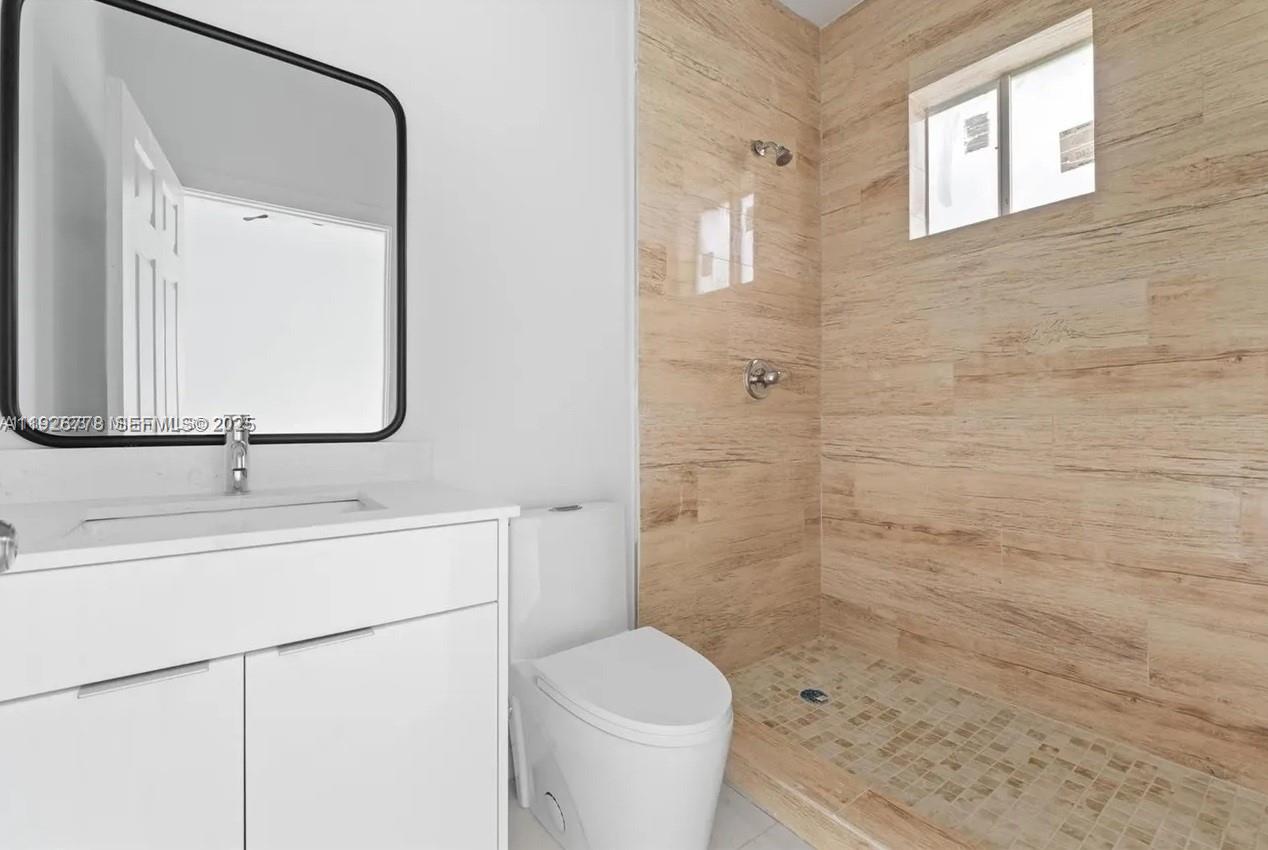 2145 Northwest 4th Street, Unit 2145 Pompano Beach, FL 33069 - Photo 12 of 13 a bathroom with a sink a toilet and shower