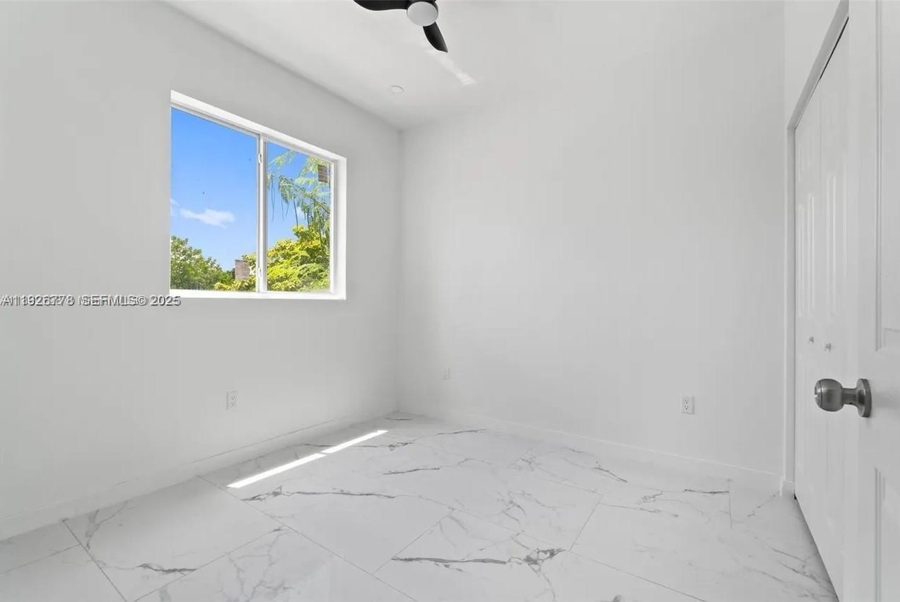 2145 Northwest 4th Street, Unit 2145 Pompano Beach, FL 33069 - Photo 13 of 13 an empty room with a window