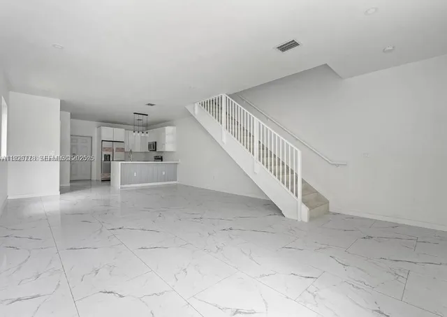 a view of a livingroom with white cabinets