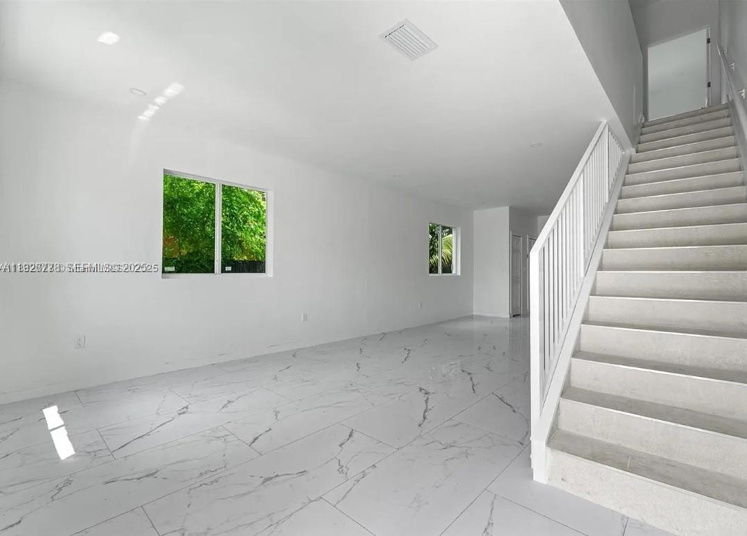 2145 Northwest 4th Street, Unit 2145 Pompano Beach, FL 33069 - Photo 8 of 13 wooden floor in an empty room with a window
