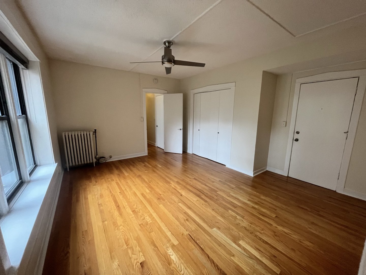 725 West Sheridan Road, Unit 402 Chicago, IL 60613 - Photo 23 of 31 wooden floor in an empty room with a window