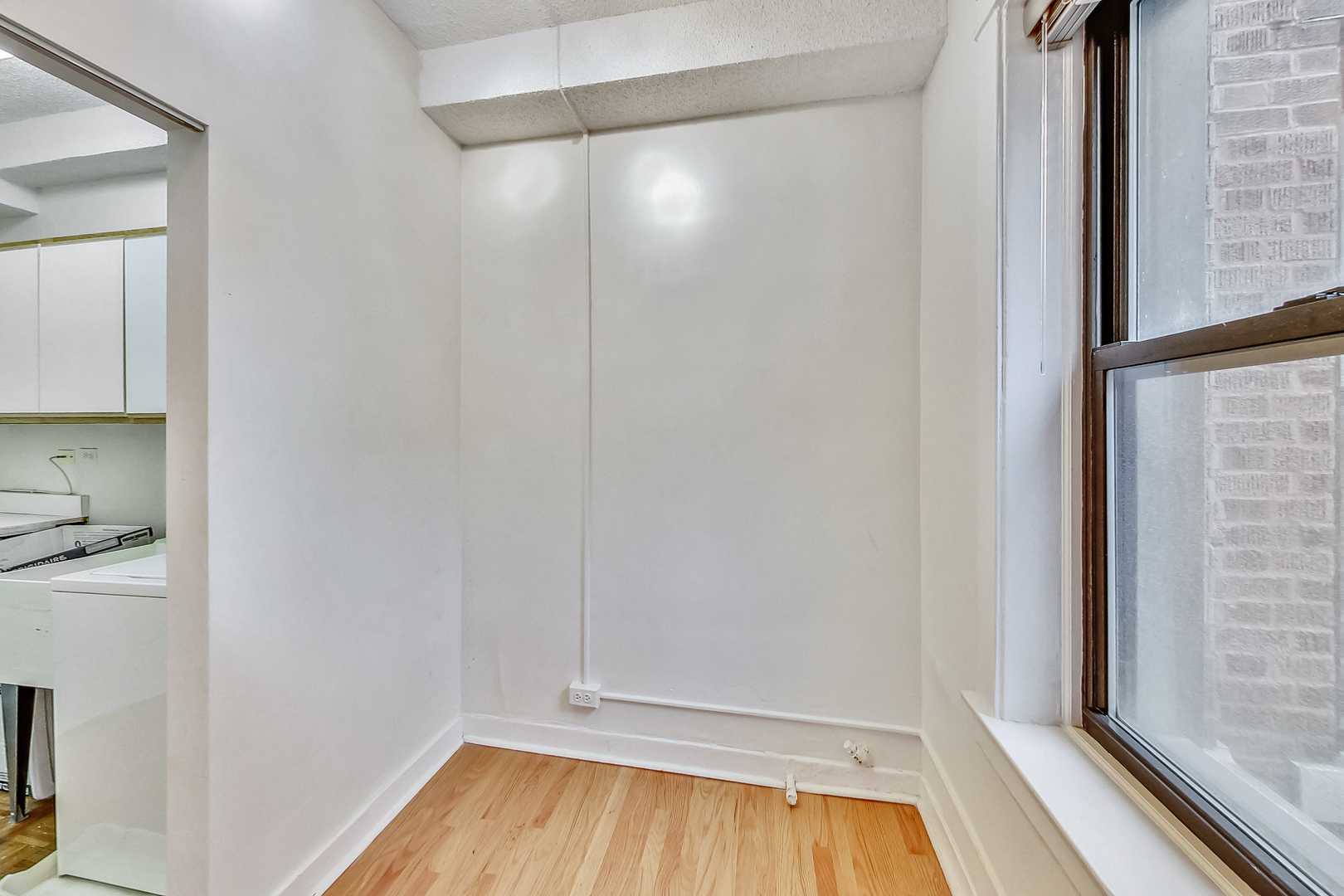 725 West Sheridan Road, Unit 402 Chicago, IL 60613 - Photo 25 of 31 a view of a small space with wooden floor and a window