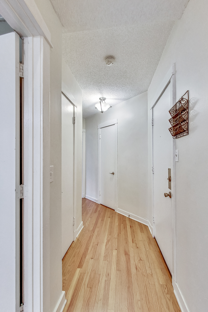 725 West Sheridan Road, Unit 402 Chicago, IL 60613 - Photo 6 of 31 a view of a room with wooden floor and window