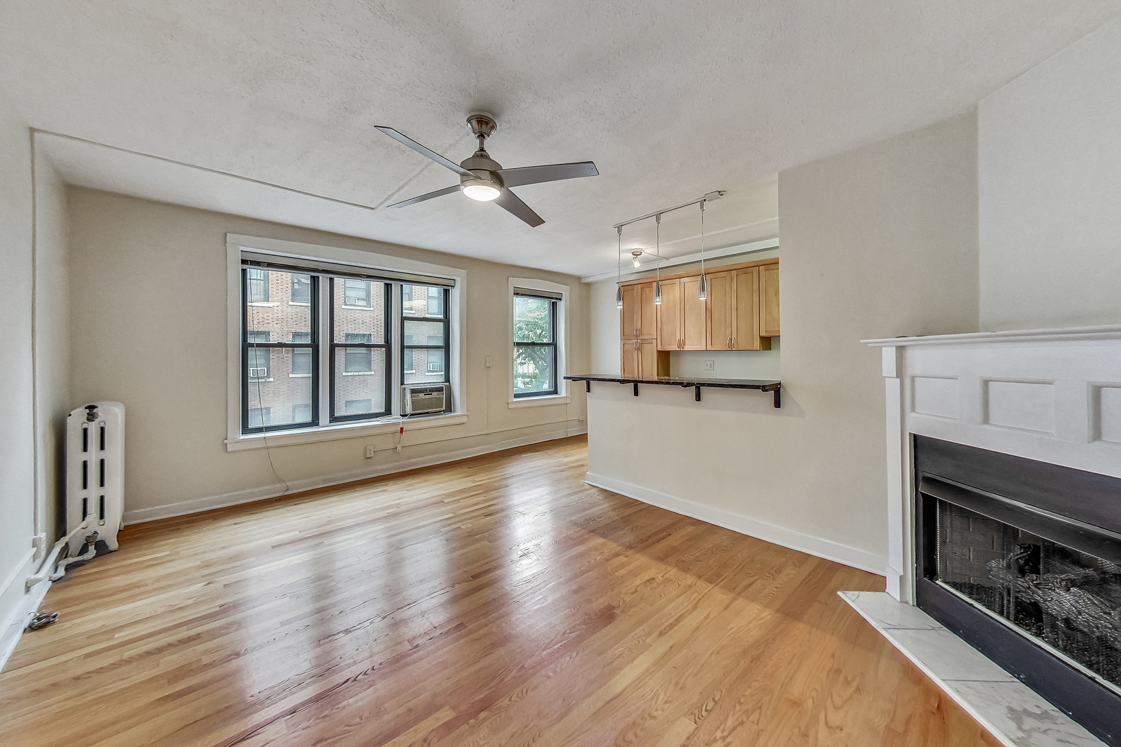 725 West Sheridan Road, Unit 402 Chicago, IL 60613 - Photo 10 of 31 a view of an empty room with a window and fireplace