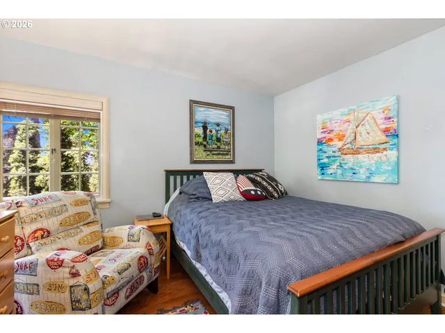 a bedroom with a bed and a painting on the wall