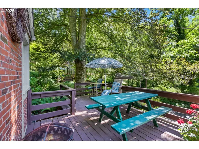 a view of a tables and chairs under an umbrella