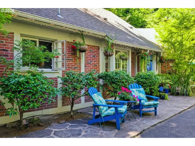 a view of a house with backyard sitting area and garden