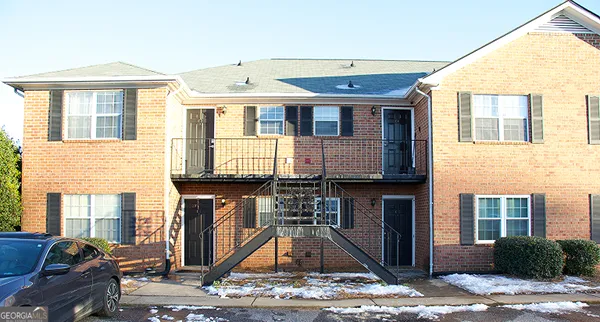 a front view of a house with parking space