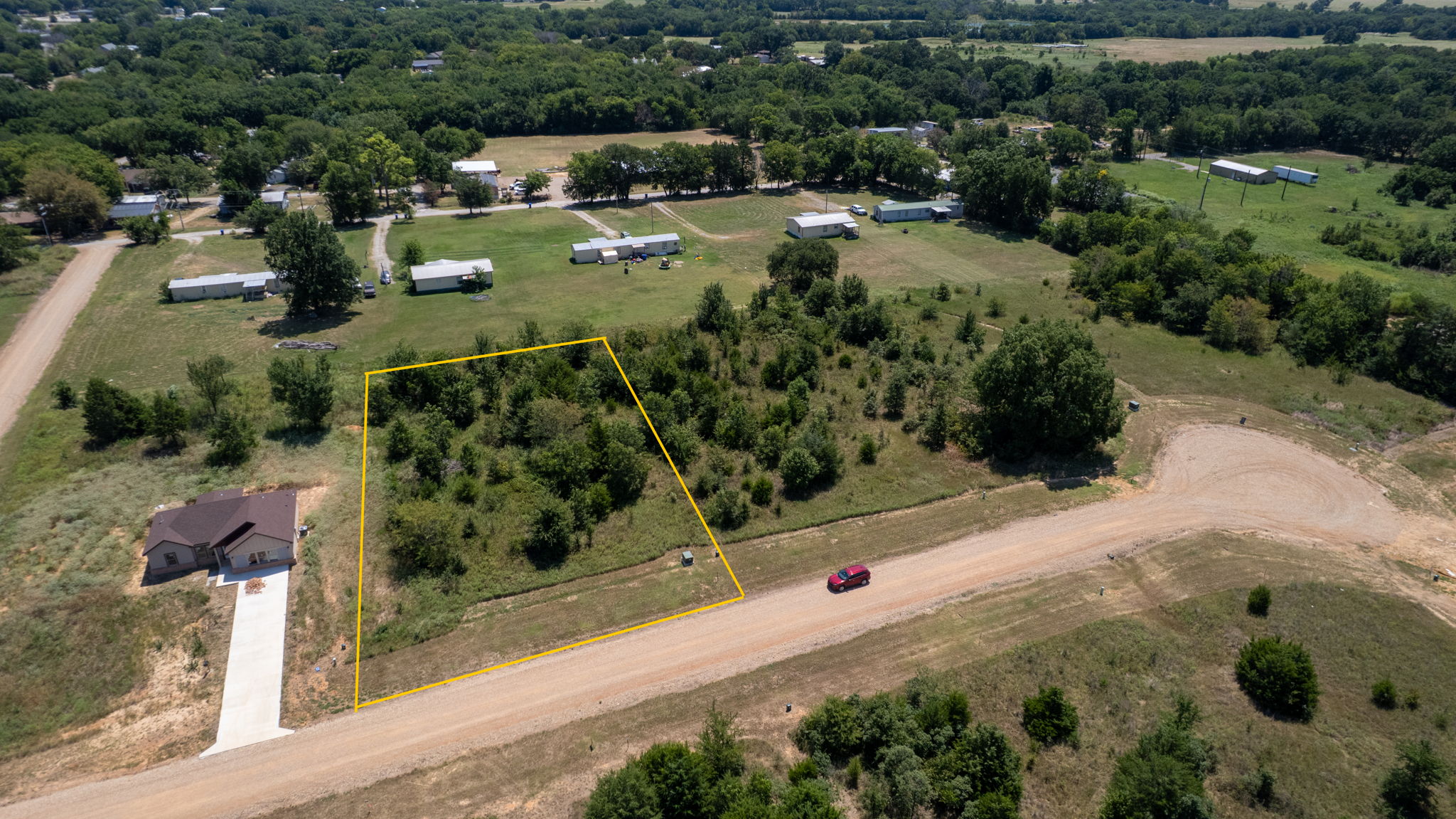 0 Redbird Lane Colbert, OK 74733 - Photo 2 of 6 Expansive rural property featuring approximately 5+ acres of cleared and treed land with mature oak specimens throughout