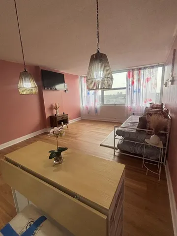 a view of a room with wooden floor and stairs