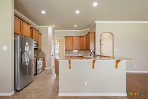 a kitchen with stainless steel appliances granite countertop a sink and a stove