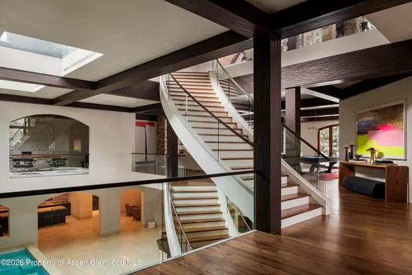 a view of entryway and hall with wooden floor