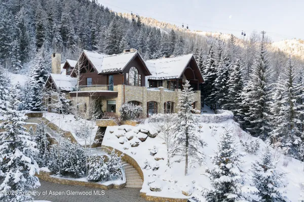 a view of a house with a yard covered with snow