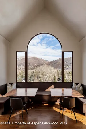 a living room with furniture a table and a large window