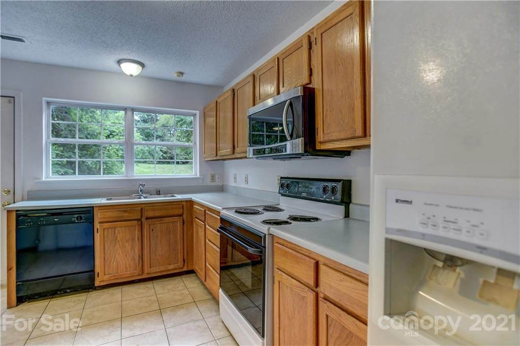 239 Valleyview Road Mooresville, NC 28117 - Photo 12 of 41 a kitchen with stainless steel appliances granite countertop a stove a sink and a microwave