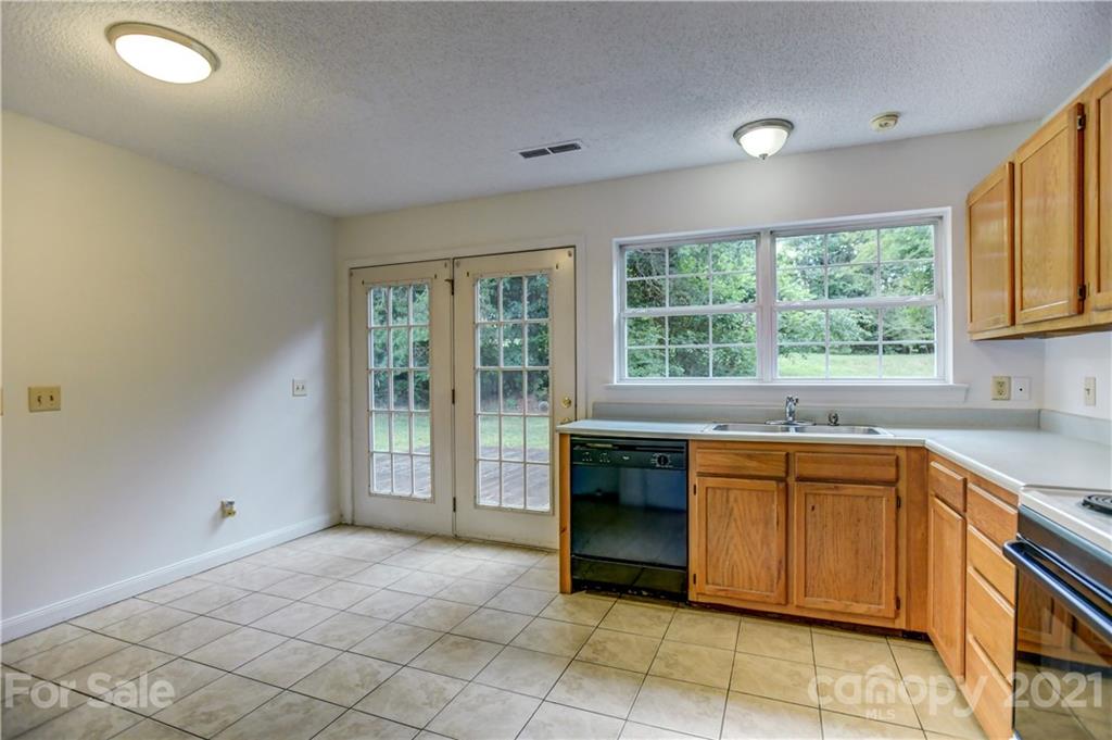 239 Valleyview Road Mooresville, NC 28117 - Photo 13 of 41 a open kitchen with granite countertop a sink and dishwasher a oven with granite countertops