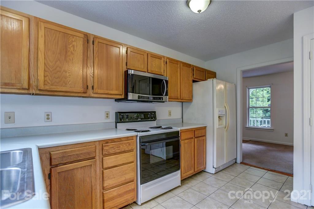 239 Valleyview Road Mooresville, NC 28117 - Photo 14 of 41 a kitchen with stainless steel appliances granite countertop a stove a sink and a microwave