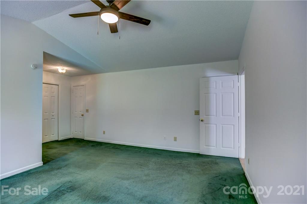 239 Valleyview Road Mooresville, NC 28117 - Photo 22 of 41 an empty room with a ceiling fan and carpet