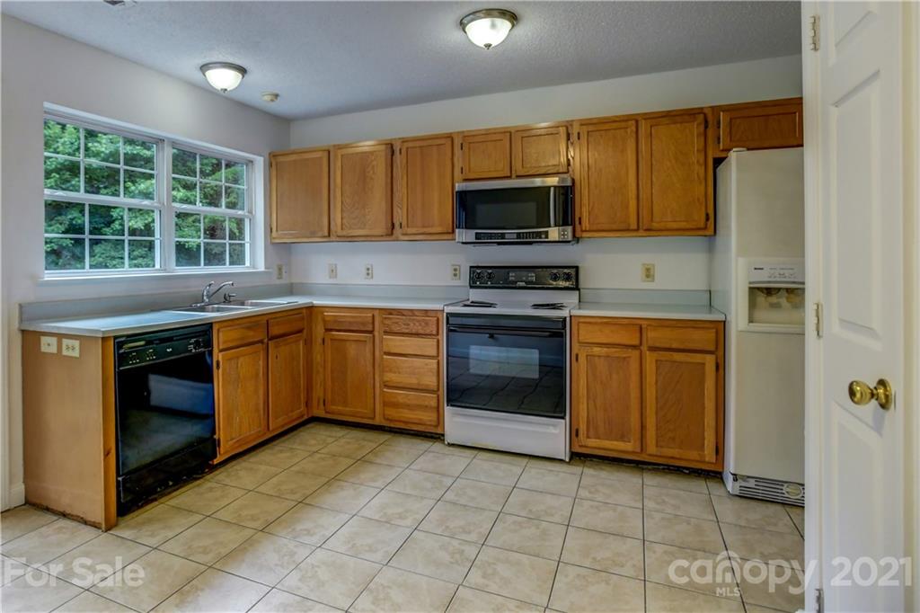 239 Valleyview Road Mooresville, NC 28117 - Photo 10 of 41 a kitchen with stainless steel appliances granite countertop a stove top oven a sink dishwasher and a refrigerator