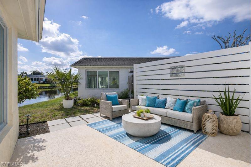 16 Knights Bridge Road Naples, FL 34112 - Photo 18 of 18 View of patio / terrace featuring an outdoor hangout area and a water view