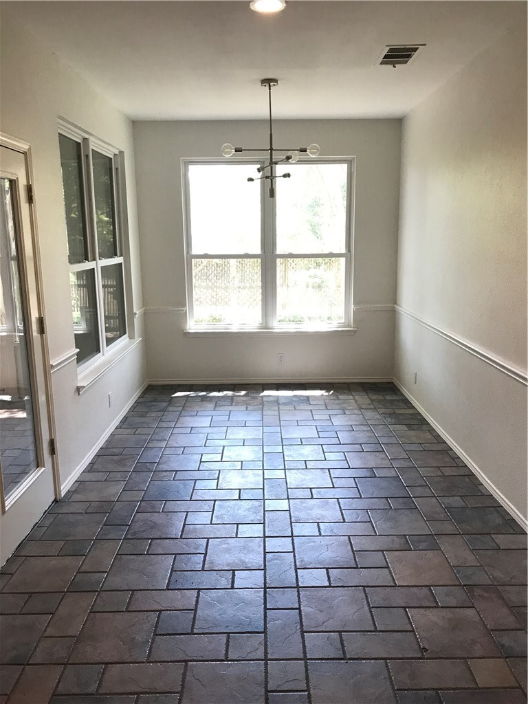 6428 Ruxton Lane Austin, TX 78749 - Photo 12 of 23 an empty room with windows and entrance