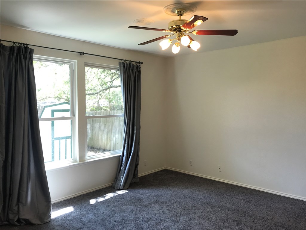 6428 Ruxton Lane Austin, TX 78749 - Photo 14 of 23 an empty room with windows and fan