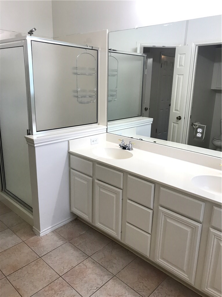 6428 Ruxton Lane Austin, TX 78749 - Photo 16 of 23 a bathroom with a double vanity sink and mirror