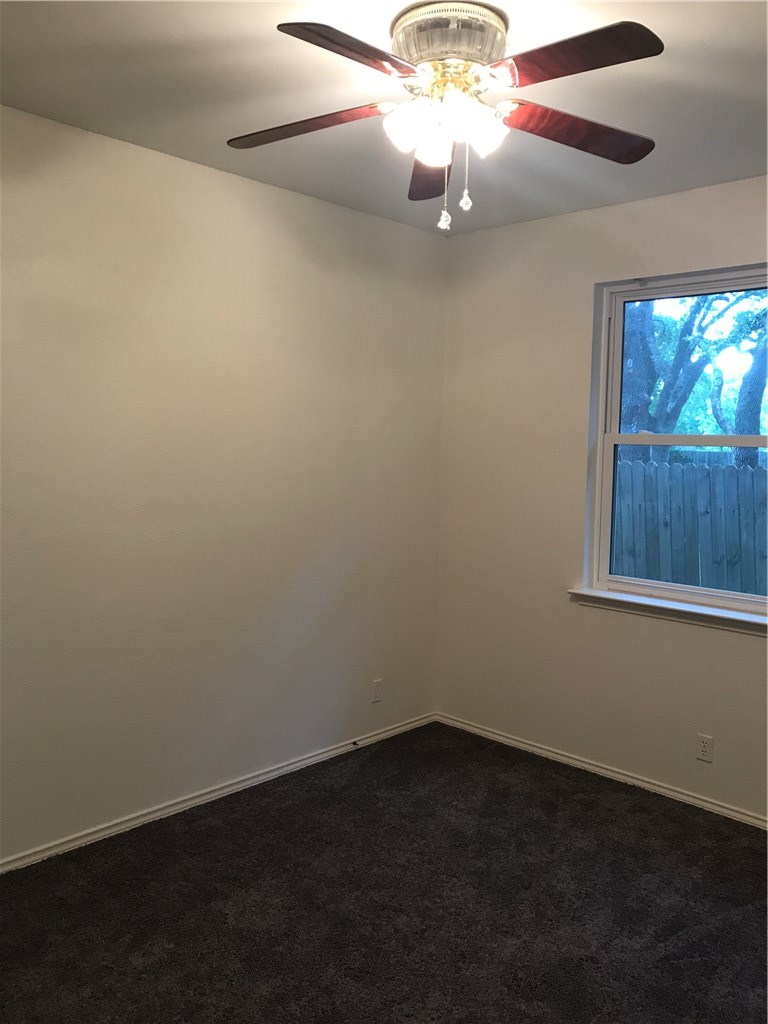 6428 Ruxton Lane Austin, TX 78749 - Photo 17 of 23 an empty room with a window and a ceiling fan