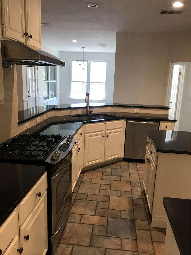 6428 Ruxton Lane Austin, TX 78749 - Photo 6 of 23 a kitchen with a sink stove and cabinets