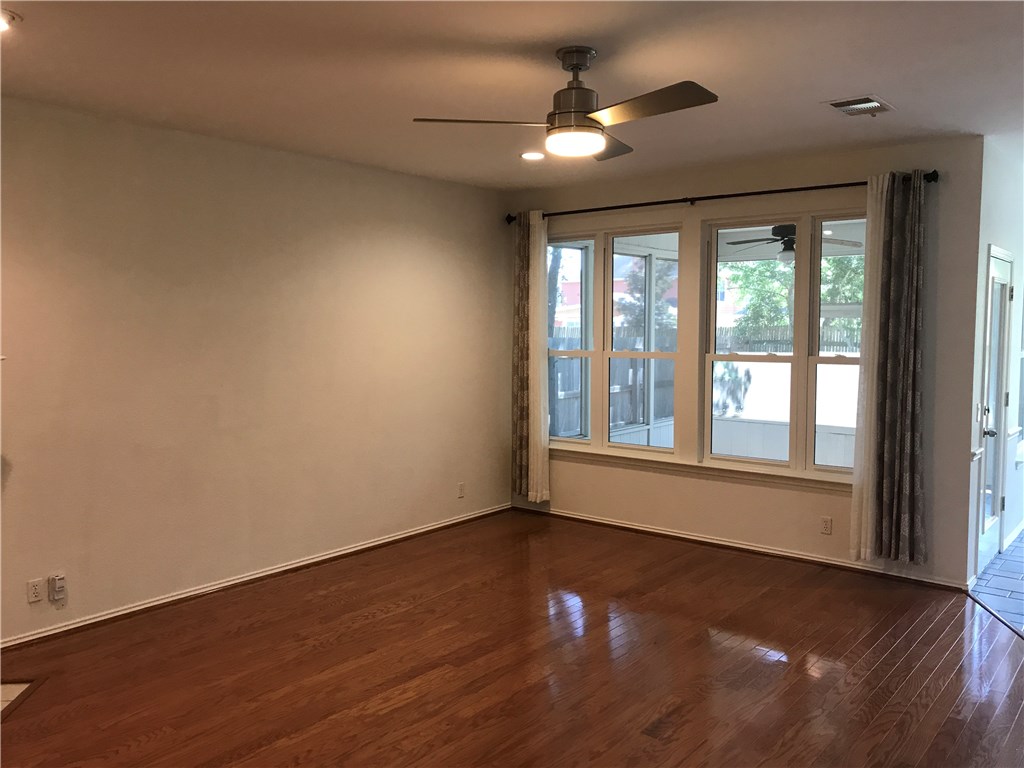 6428 Ruxton Lane Austin, TX 78749 - Photo 7 of 23 a view of an empty room with wooden floor and a window