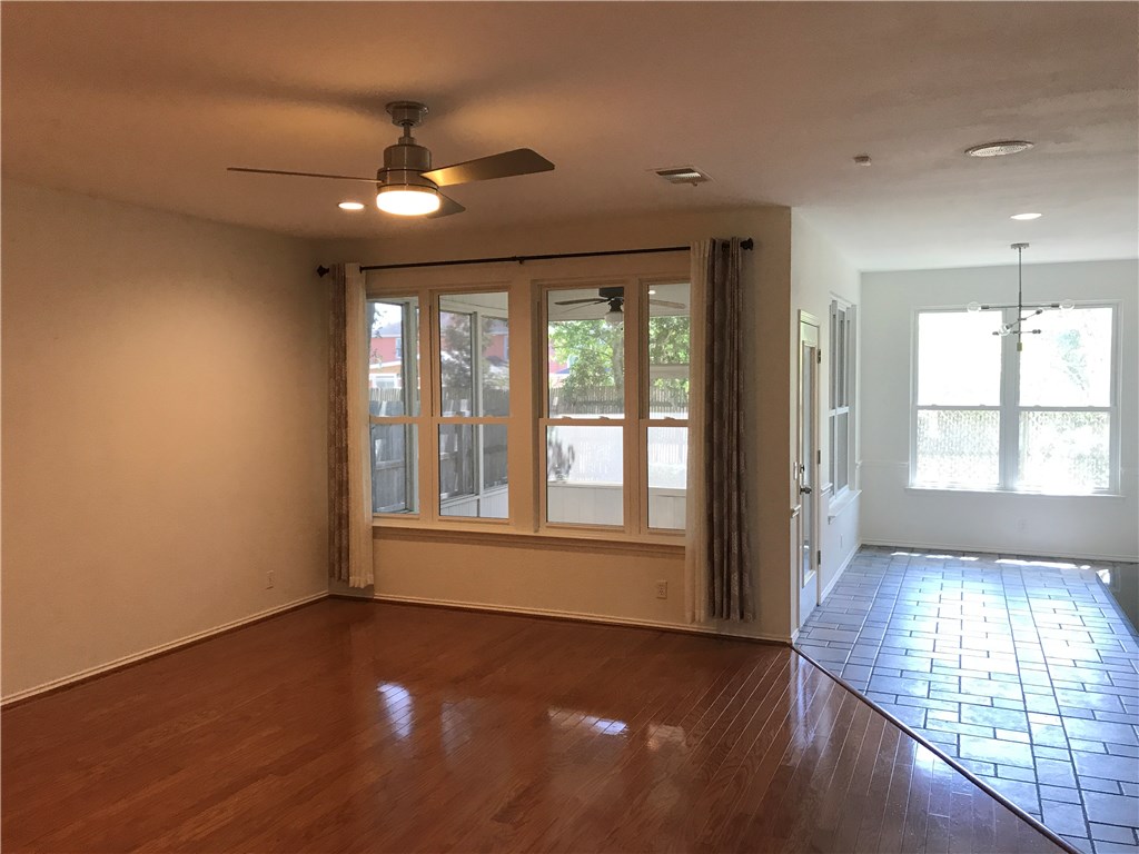 6428 Ruxton Lane Austin, TX 78749 - Photo 10 of 23 a view of an empty room with wooden floor and a window