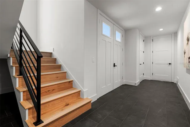 a kitchen with stainless steel appliances a sink a stove a refrigerator and cabinets