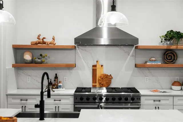 a bedroom with a large bed and a potted plant