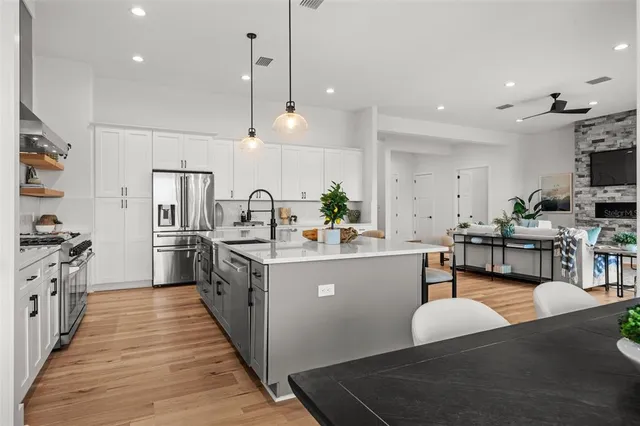 a living room with furniture lamp and a potted plant