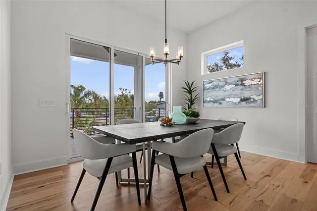 a living room with furniture a potted plant and a flat screen tv
