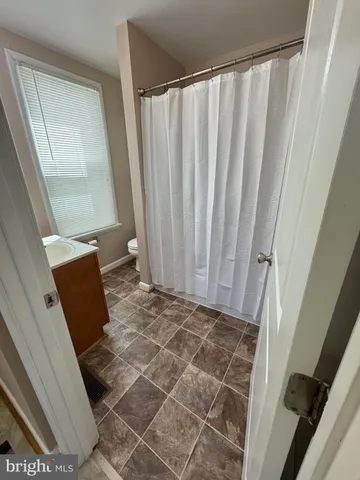 a bathroom with a sink a toilet and mirror