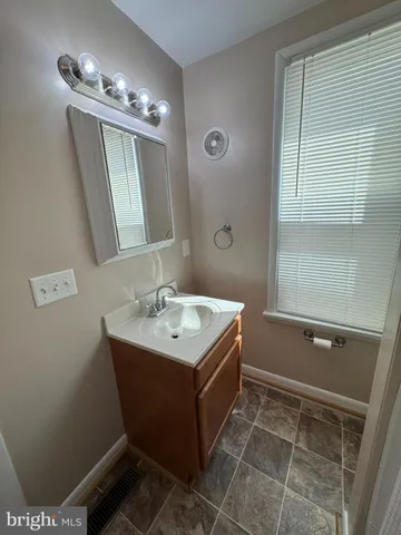 a kitchen with granite countertop a sink stove and cabinets