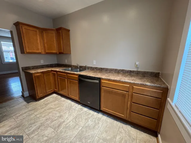 a view of kitchen with stainless steel appliances granite countertop a refrigerator and a sink