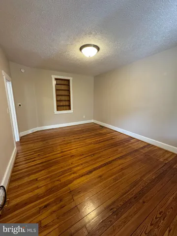 a view of a room with wooden floor and staircase