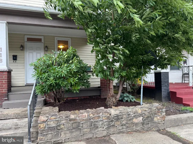 a front view of a house with plants