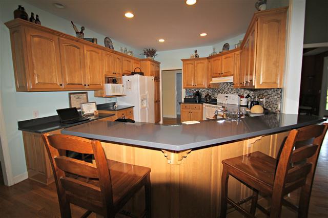 87 Oak Hollow Road Manchester, TN 37355 - Photo 6 of 18 Big kitchen with custom cabinets and quartz counter tops. Large bar provides more seating.